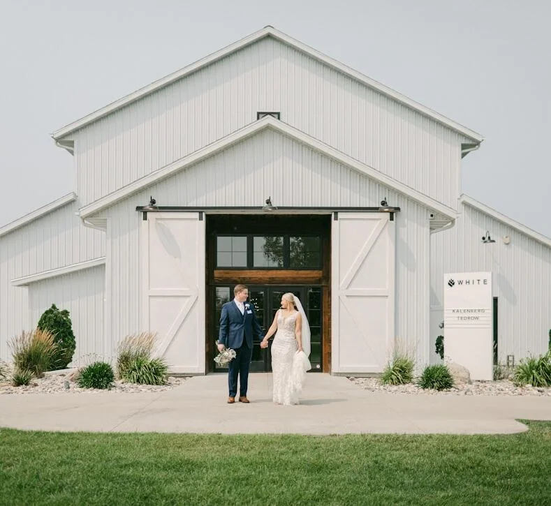 Couple standing outside their wedding venue