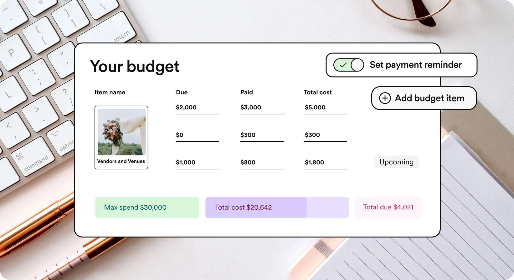 Couple planning wedding budget with laptop and wedding materials