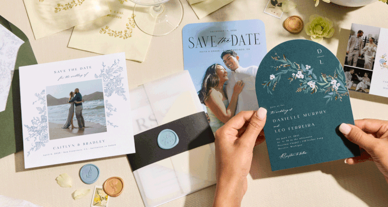 Flat lay of invitations and envelopes with a bouquet of flowers