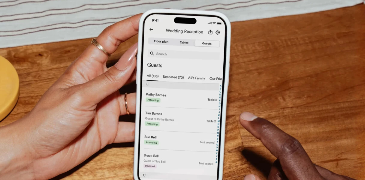 Zola iOS app showing guest list synced to a wedding seating chart
