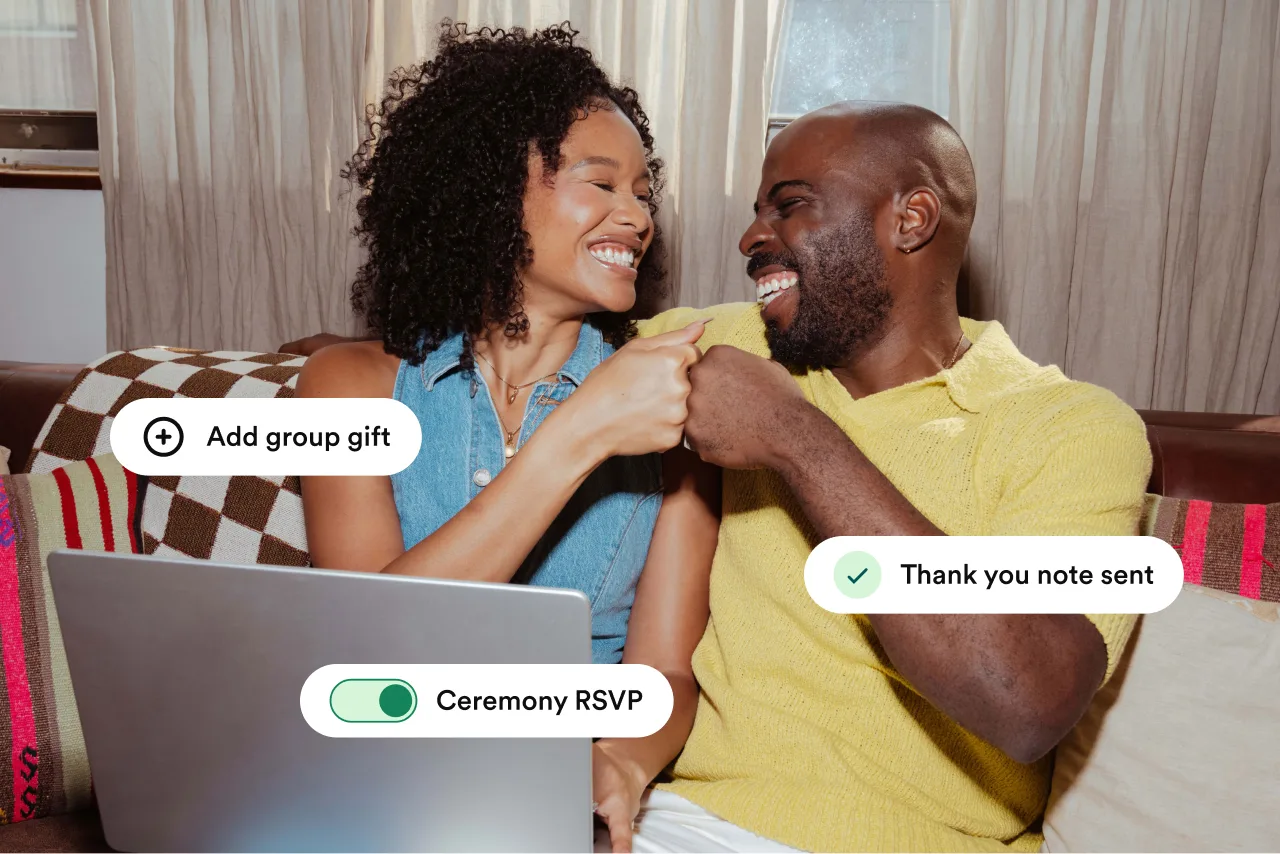 A couple laughing together while using Zola registry, RSVP, and thank-you note features