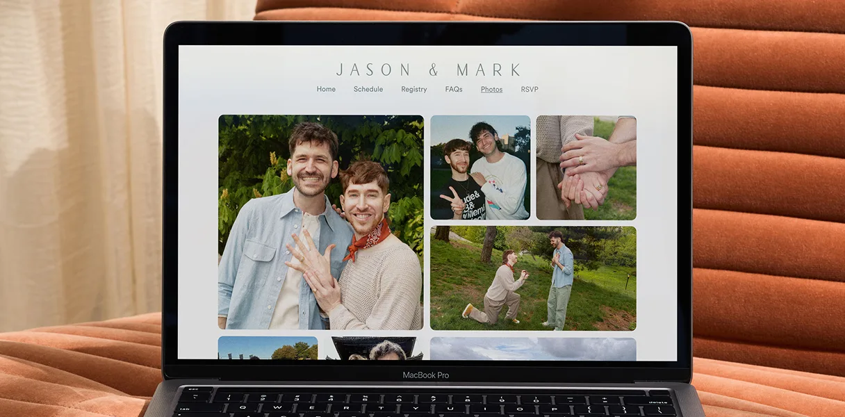 A laptop showing a Zola wedding website photo and video gallery