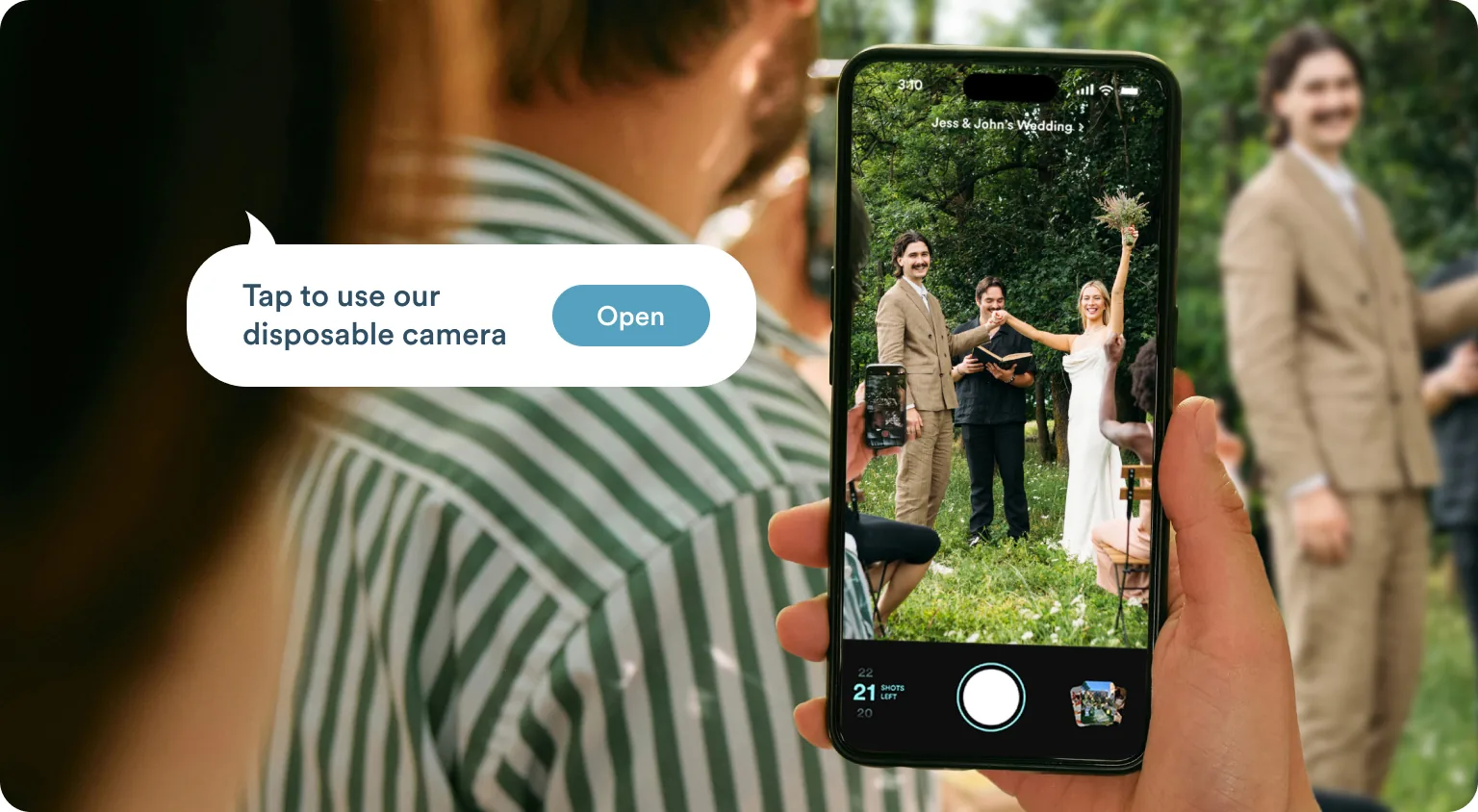 A guest photographs the couple with a phone prompting them to open the disposable camera
