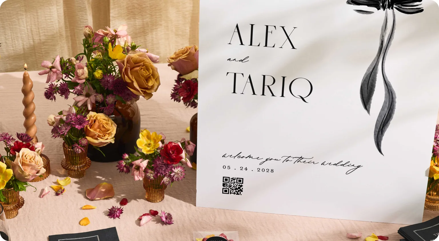A wedding welcome sign for Alex and Tariq with a QR code, surrounded by flowers